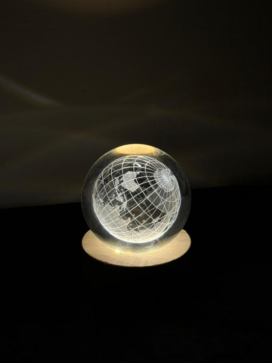 Glowing crystal ball with a world map design on a dark background