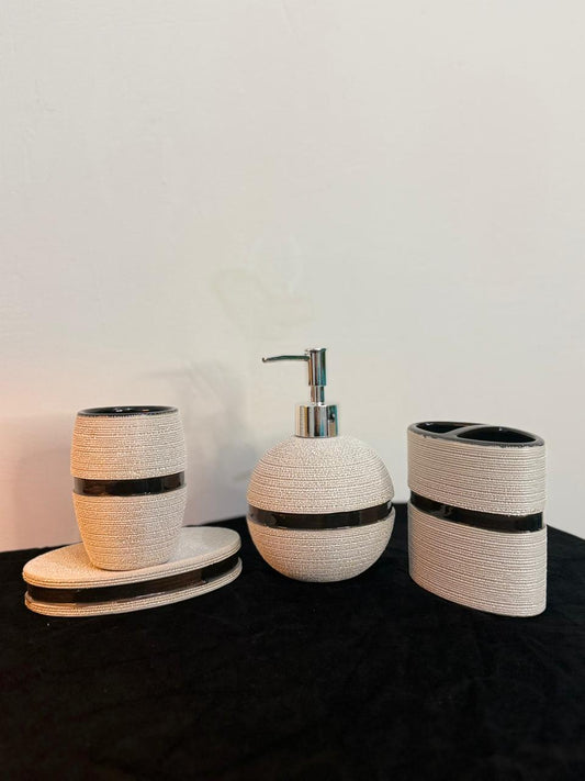 Bathroom accessory set with woven design on a black surface